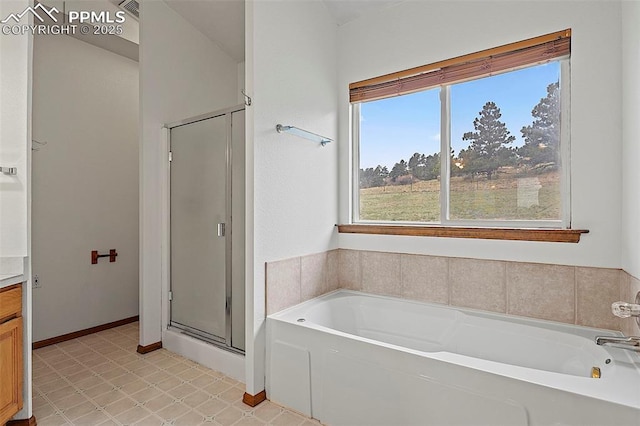 17880 Plains Edge Ct, Peyton, CO 80831 - full bathroom with tile patterned floors, plenty of natural light, a shower stall, and a bath