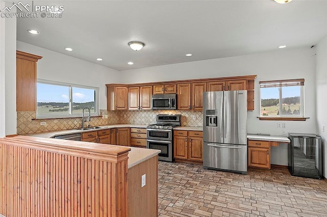 17880 Plains Edge Ct, Peyton, CO 80831 - kitchen with wine cooler, light countertops, a sink, a wealth of natural light, and stainless steel appliances
