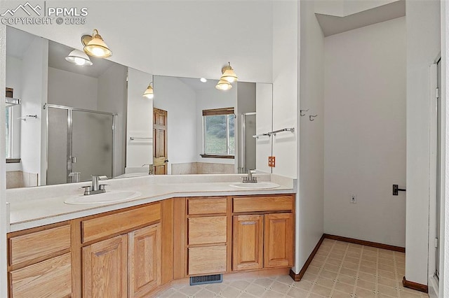 17880 Plains Edge Ct, Peyton, CO 80831 - full bath with a sink, baseboards, a shower stall, and double vanity