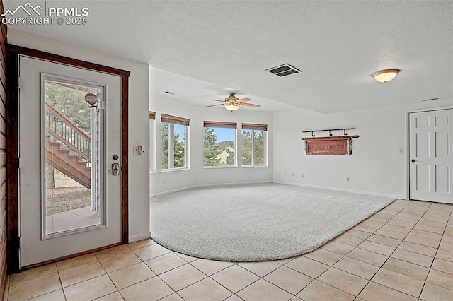 17880 Plains Edge Ct, Peyton, CO 80831 - foyer featuring baseboards, ceiling fan, light carpet, and light tile patterned flooring
