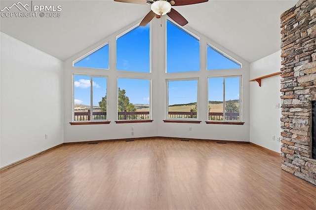 17880 Plains Edge Ct, Peyton, CO 80831 - spare room with plenty of natural light, ceiling fan, a stone fireplace, and lofted ceiling