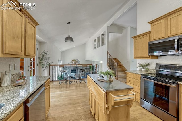 26 Mountain View Rd, Manitou Springs, CO 80829 - kitchen featuring appliances with stainless steel finishes, light wood finished floors, light stone counters, decorative light fixtures, and high vaulted ceiling