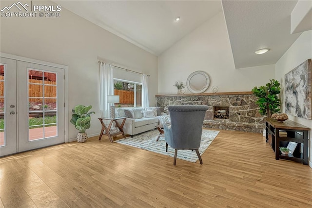26 Mountain View Rd, Manitou Springs, CO 80829 - living area featuring high vaulted ceiling, french doors, wood finished floors, a fireplace, and baseboards