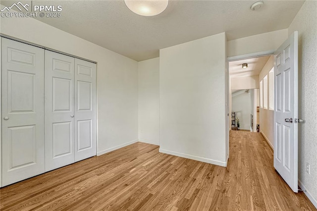 26 Mountain View Rd, Manitou Springs, CO 80829 - unfurnished bedroom featuring light wood-style flooring, a closet, and baseboards