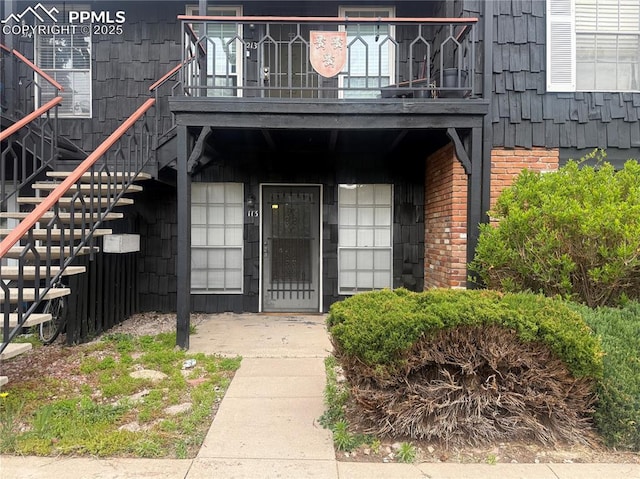 view of exterior entry featuring brick siding