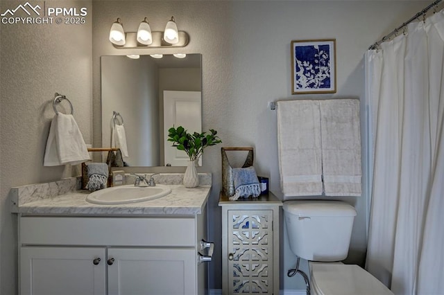7352 Cornice Pt, Colorado Springs, CO 80923 - full bath with vanity, a textured wall, and toilet