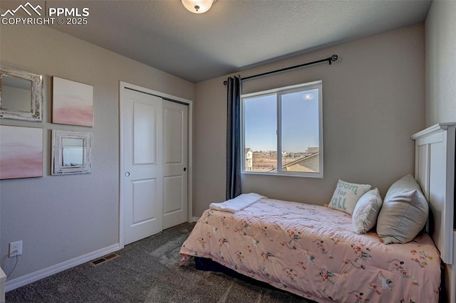 7352 Cornice Pt, Colorado Springs, CO 80923 - bedroom with a closet, baseboards, visible vents, and dark colored carpet