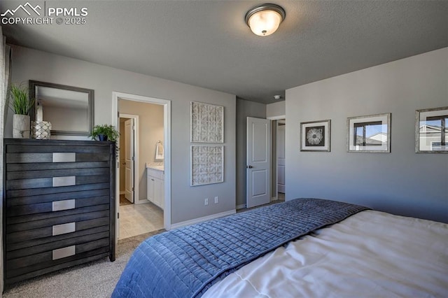 7352 Cornice Pt, Colorado Springs, CO 80923 - bedroom with light colored carpet, baseboards, a textured ceiling, and ensuite bath