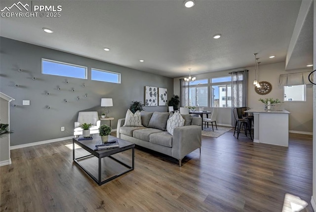 7352 Cornice Pt, Colorado Springs, CO 80923 - living room featuring recessed lighting, baseboards, a notable chandelier, and wood finished floors