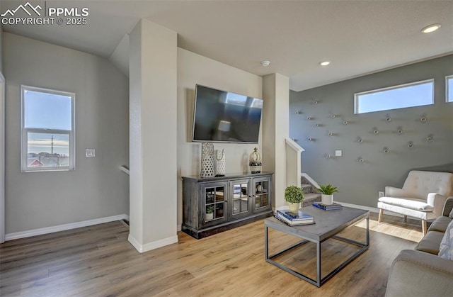 7352 Cornice Pt, Colorado Springs, CO 80923 - living area with baseboards, recessed lighting, wood finished floors, and stairway