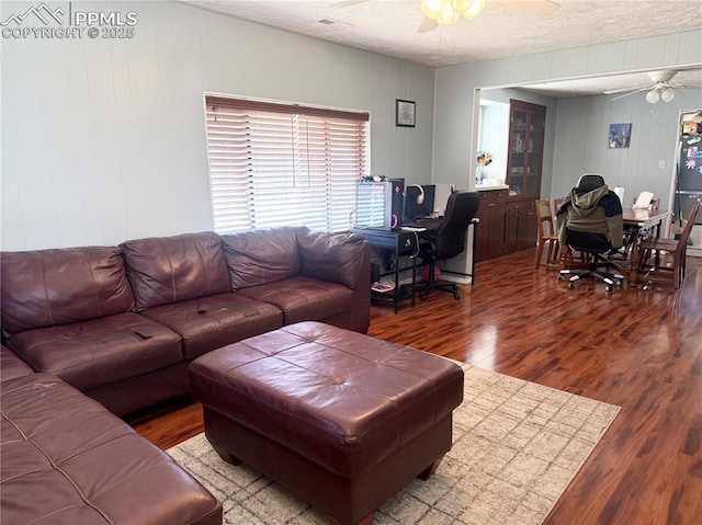 1322 Lincoln Ave, La Junta, CO 81050 - living area featuring a textured ceiling, ceiling fan, and wood finished floors