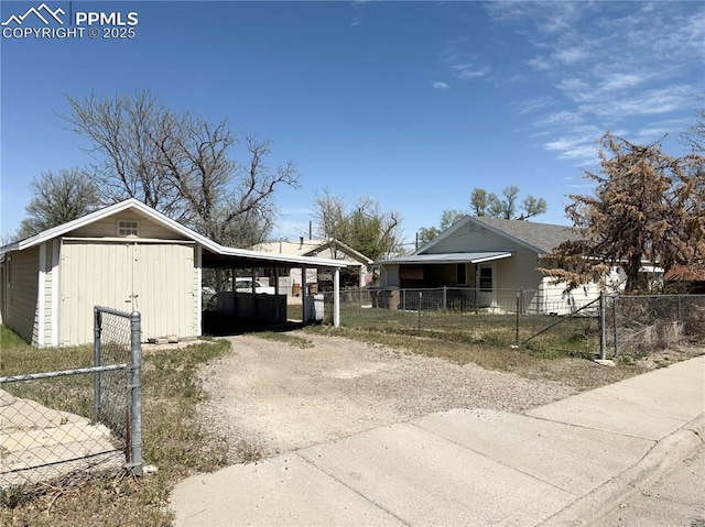 1322 Lincoln Ave, La Junta, CO 81050 - view of front of house featuring fence private yard, an outdoor structure, and driveway