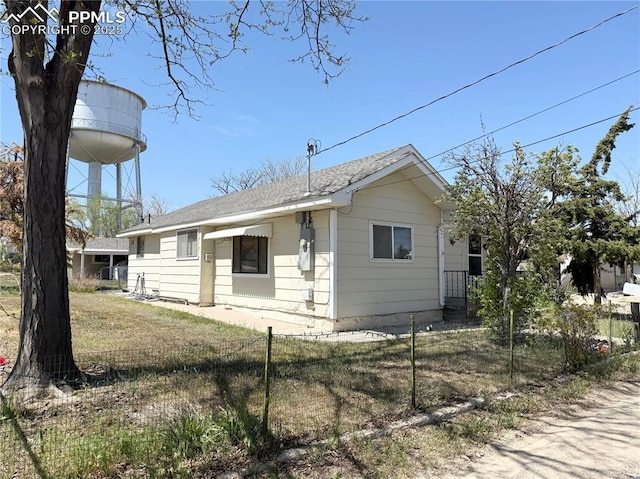 1322 Lincoln Ave, La Junta, CO 81050 - view of side of home with fence private yard and roof with shingles