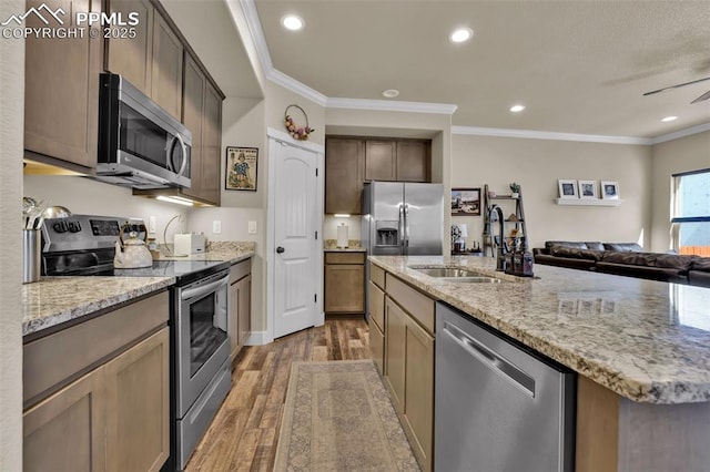835 Redemption Pt, Colorado Springs, CO 80905 - kitchen with ornamental molding, light wood-style floors, appliances with stainless steel finishes, and a sink
