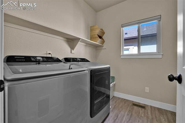 835 Redemption Pt, Colorado Springs, CO 80905 - laundry room featuring baseboards, visible vents, washing machine and clothes dryer, light wood-style floors, and laundry area