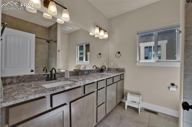 835 Redemption Pt, Colorado Springs, CO 80905 - full bath with baseboards, visible vents, a sink, tile patterned flooring, and double vanity