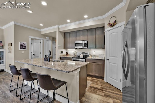 835 Redemption Pt, Colorado Springs, CO 80905 - kitchen with recessed lighting, dark wood finished floors, a sink, crown molding, and stainless steel appliances