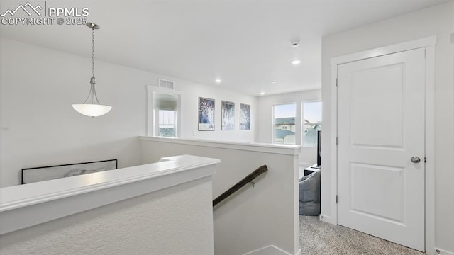 6555 Roundtail Way, Colorado Springs, CO 80925 - corridor with carpet, visible vents, an upstairs landing, and recessed lighting