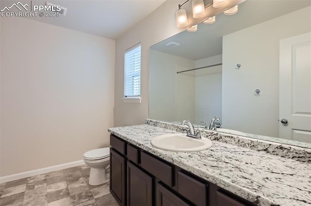 full bath with baseboards, toilet, and vanity