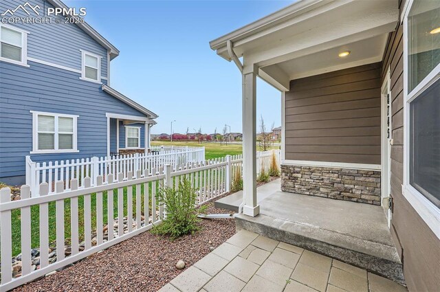 view of patio / terrace featuring fence and covered porch