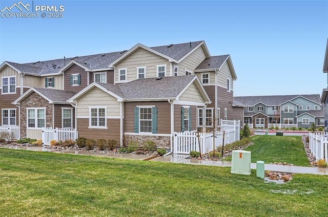 view of front of property with a shingled roof, stone siding, and a residential view