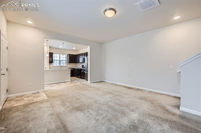 unfurnished living room featuring light carpet, recessed lighting, and baseboards