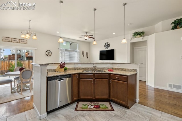 10842 Scenic Brush Dr, Peyton, CO 80831 - kitchen featuring stainless steel dishwasher, a sink, a ceiling fan, pendant lighting, and light stone countertops