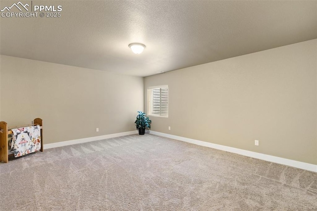 10842 Scenic Brush Dr, Peyton, CO 80831 - empty room featuring carpet floors, baseboards, and a textured ceiling