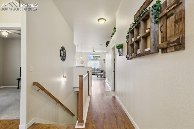 10842 Scenic Brush Dr, Peyton, CO 80831 - hallway with an upstairs landing, baseboards, and wood finished floors