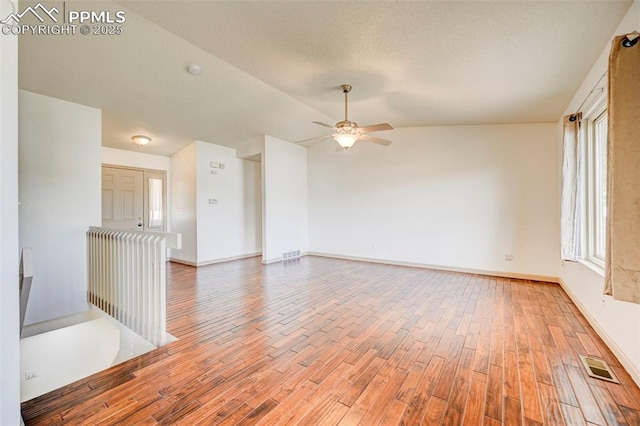 1120 Pipestone Ct, Colorado Springs, CO 80911 - spare room with wood finished floors, ceiling fan, vaulted ceiling, and baseboards