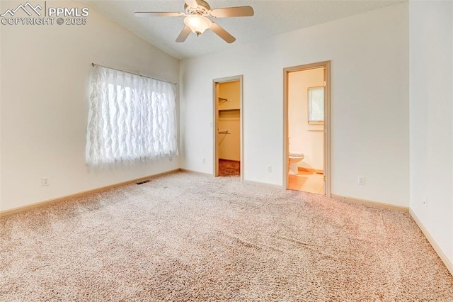 1120 Pipestone Ct, Colorado Springs, CO 80911 - unfurnished bedroom with a walk in closet, carpet floors, lofted ceiling, baseboards, and a closet