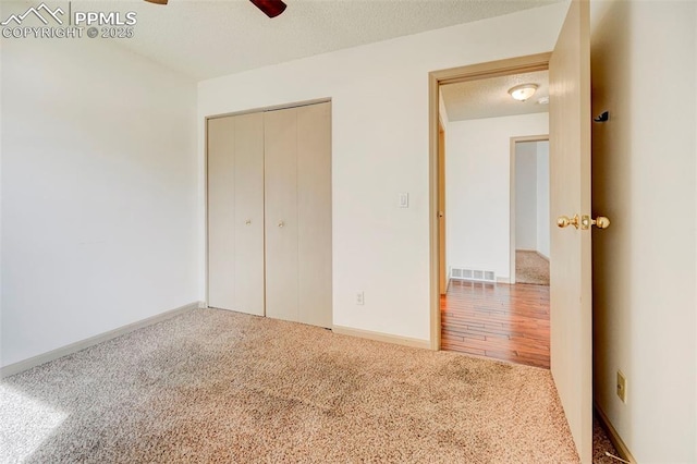 1120 Pipestone Ct, Colorado Springs, CO 80911 - unfurnished bedroom featuring carpet floors, a closet, baseboards, a ceiling fan, and a textured ceiling