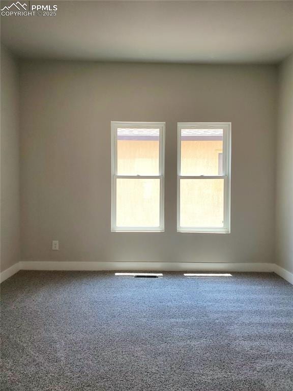 carpeted spare room with baseboards