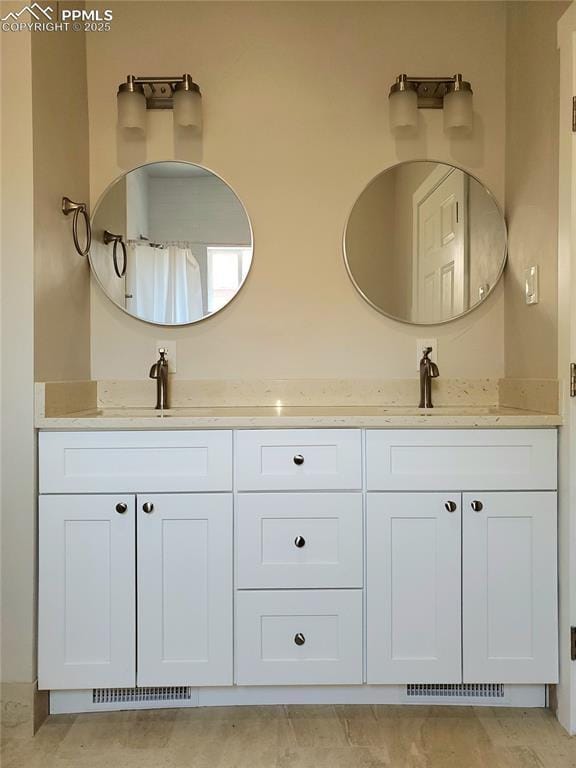 full bathroom with visible vents, a sink, and double vanity