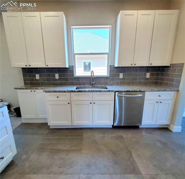 kitchen with stainless steel dishwasher, white cabinetry, and a sink
