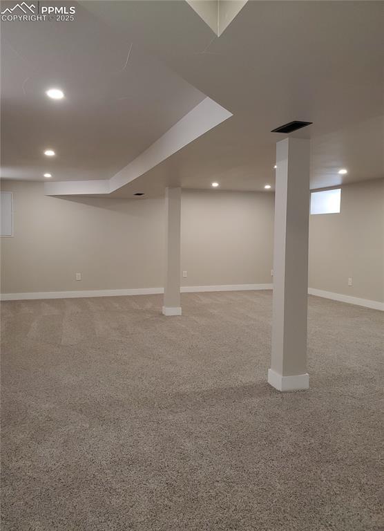 finished basement with baseboards, recessed lighting, and light colored carpet