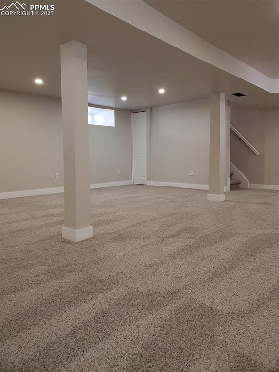 finished below grade area featuring recessed lighting, baseboards, and stairway