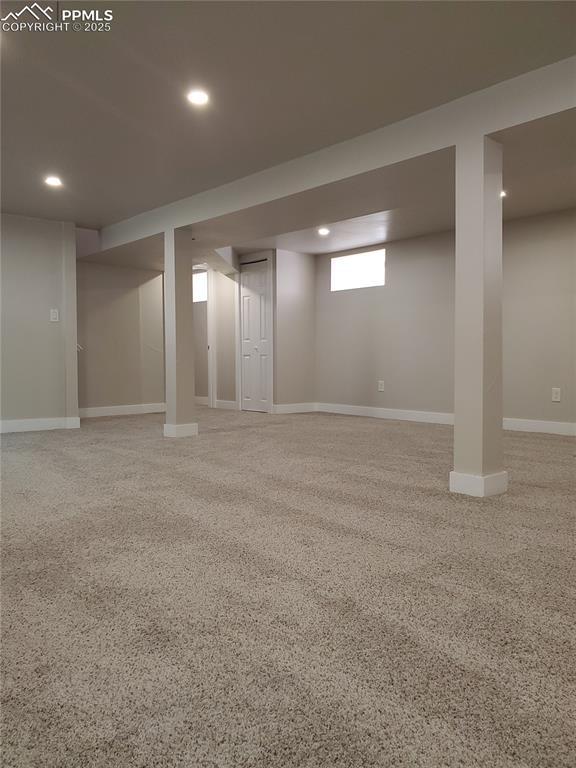 basement with recessed lighting and baseboards