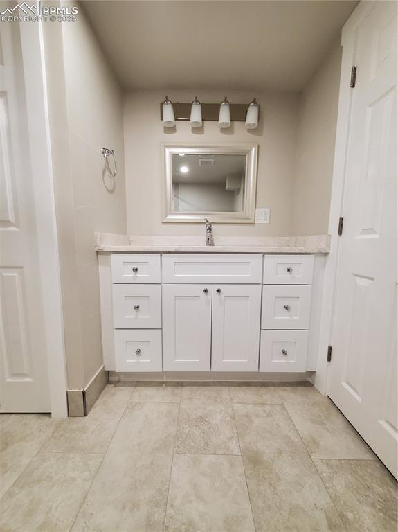 bathroom with vanity and tile patterned floors