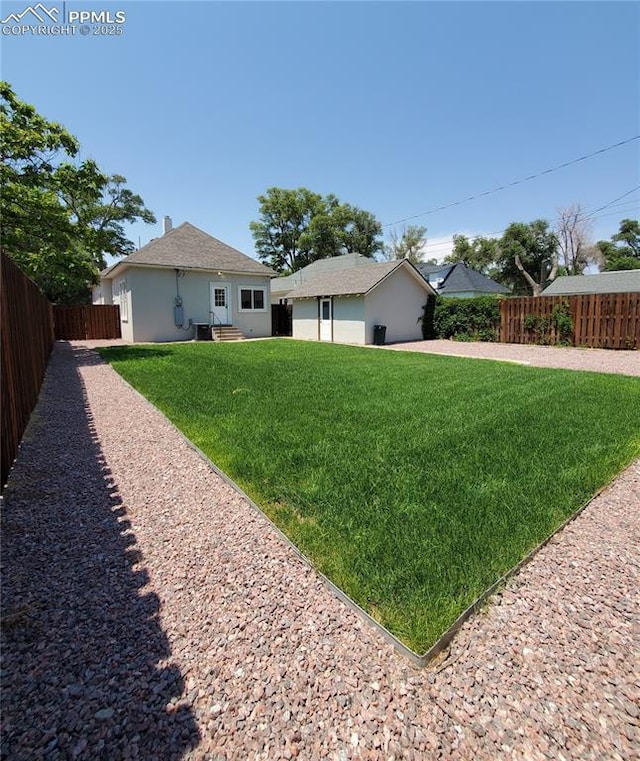 view of yard featuring fence private yard and entry steps