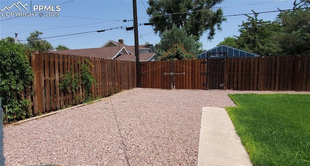 view of yard featuring a gate and a fenced backyard