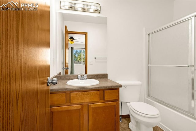 bathroom featuring toilet, vanity, a ceiling fan, and bath / shower combo with glass door