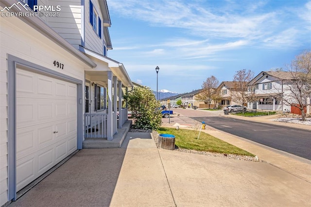 view of home's exterior featuring a garage and a residential view