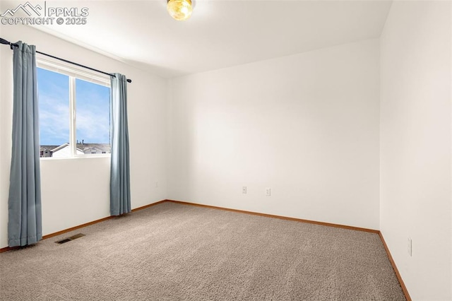 unfurnished room with carpet floors and baseboards