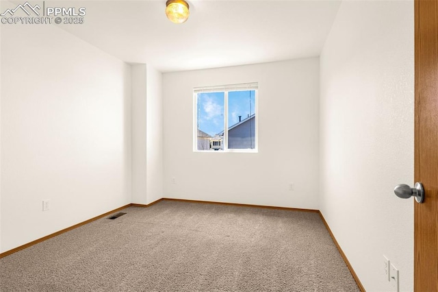 empty room with carpet floors and baseboards