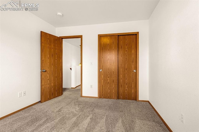 unfurnished bedroom featuring carpet flooring, a closet, and baseboards