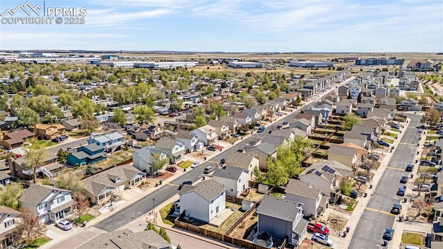 aerial view of property and surrounding area featuring nearby suburban area