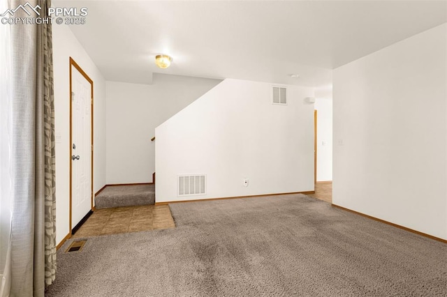 unfurnished living room with carpet floors and baseboards
