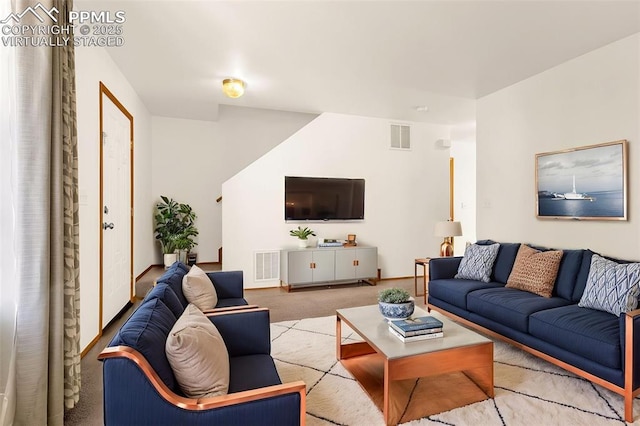 carpeted living room with baseboards