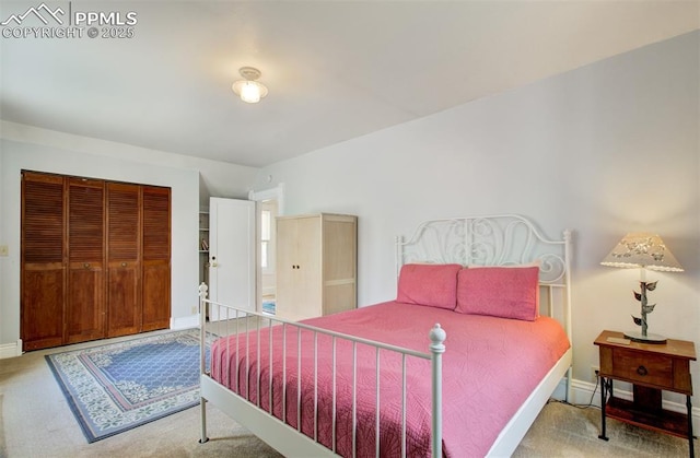 bedroom featuring carpet, a closet, and baseboards